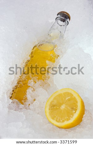 A nice picture of a beerbottle on ice. Very fresh. This version has a lemon.