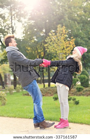 A picture of a young couple having fun in the park