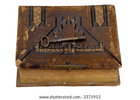 Antique photo album with old-fashioned key on top of it, isolated on white
