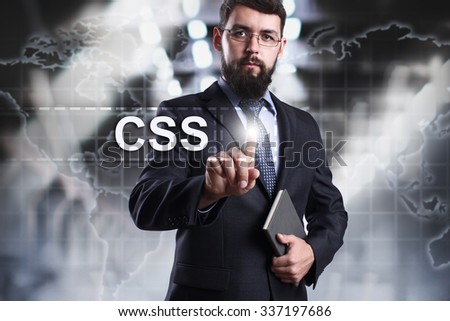 Businessman pressing button on touch screen interface and select CSS. Business concept. Internet concept.
