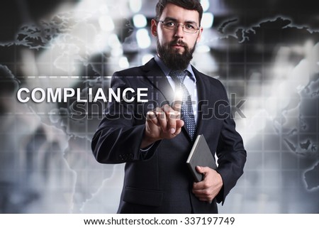Businessman pressing button on touch screen interface and select Compliance. Business concept. Internet concept.