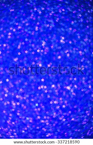 Festive Christmas background with stars. Abstract twinkled bright background with bokeh defocused lights