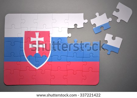broken puzzle with the national flag of slovakia on a gray background