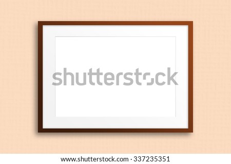  Blank photo frame on light  textured wallpaper.