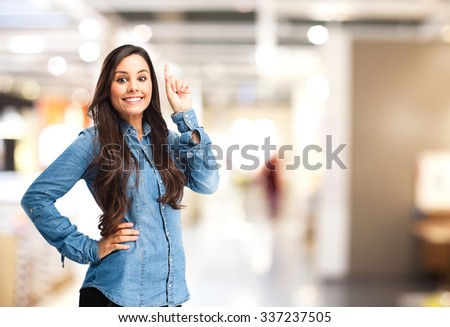 happy young woman pointing up