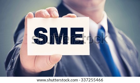 SME word on the card held by a man hand, vintage tone