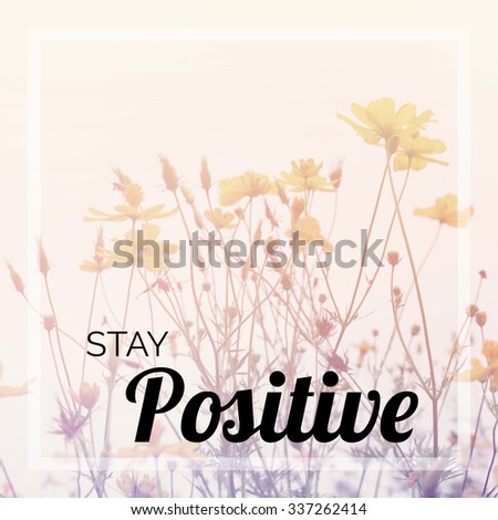 Inspirational quote on blurred wild flowers background with vintage filter