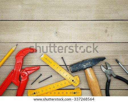 Under Construction / Do It Yourself / Handyman Tools on a Wooden Background