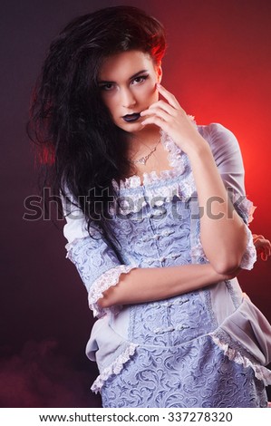 portrait of halloween vampire woman aristocrat with stage makeup