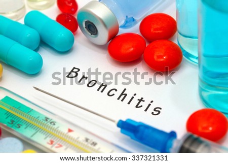 Bronchitis - diagnosis written on a white piece of paper. Syringe and vaccine with drugs.
