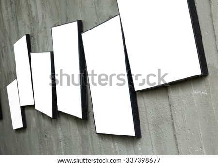 blank photo frame hanging on cement wall interior room