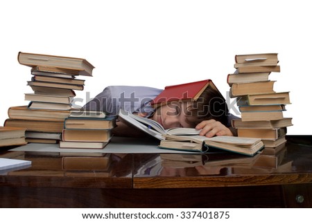 A tired student is sleeping among stacks of books and using a book as a pillow, he put his face on a book and closed his eyes. The photo is isolated on a white background.