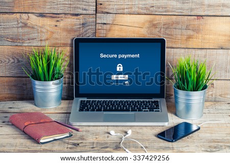 Secure payment message in a laptop screen. On line banking concept.