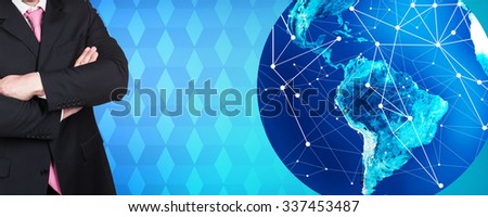 Businessman stands near big earth ball on the blue rombus background. Elements of this image furnished by NASA