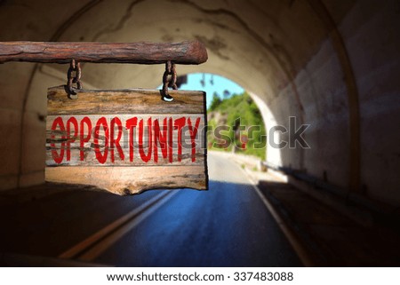 Opportunity motivational phrase sign on old wood with blurred background