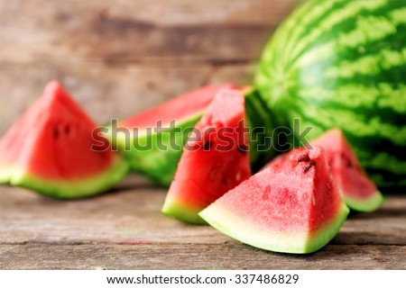 Fresh sliced watermelon wooden background Royalty-Free Stock Photo #337486829