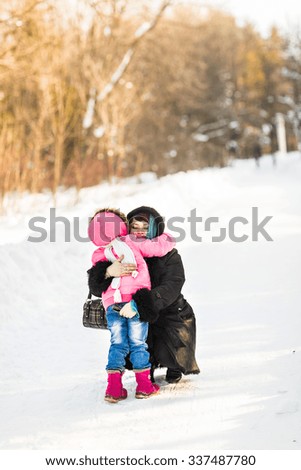 mother with her daughter in winter park