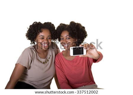 1 sisters or friends holding a cell phone camera taking a picture