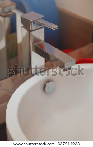 Sink and water tap. Horizontal close-up photo