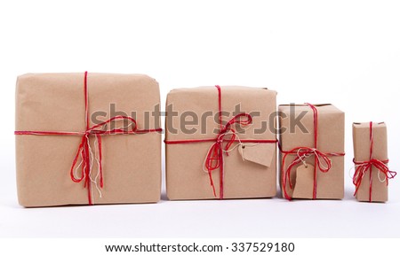 gifts in a row. kraft paper, red ribbons. vintage, rustic, the family, each according to the present. 4 gift