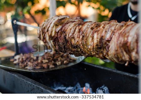 Cook fries grilled meat shawarma . Hot fresh delicious kebabs - a fine selection of street food . Charcoal and meat close-up.
 Royalty-Free Stock Photo #337534781