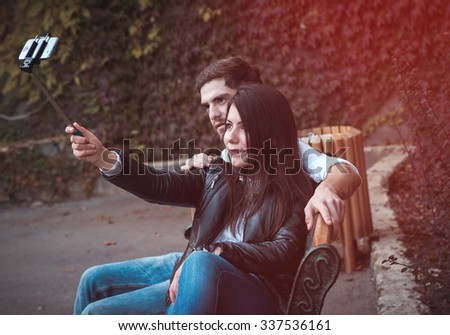 young couple in park doing selfie