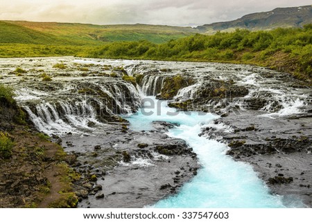 Bruarfoss waterfall with turquoise water cascades at sunset, Iceland