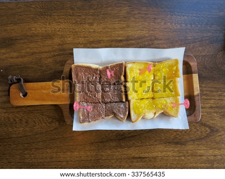 slices bread with fruit jam and chocolate  on wooden table