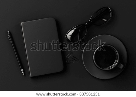 Blank diary, pen, cup of coffee, clips and glasses on black table 3D Render