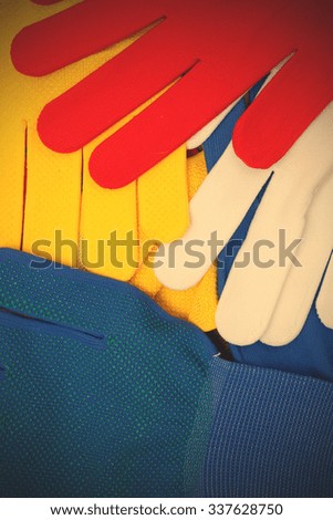 colorful set of working gloves on an old wooden surface. instagram image filter retro style