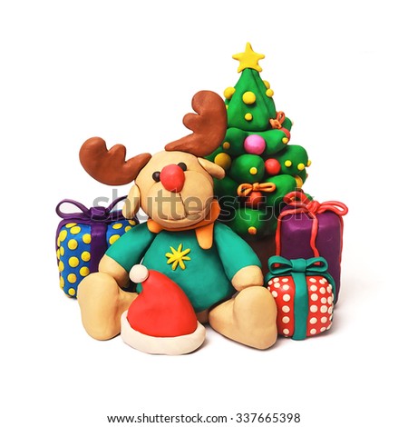Plasticine cartoon deer with present and Christmas tree on a white background
