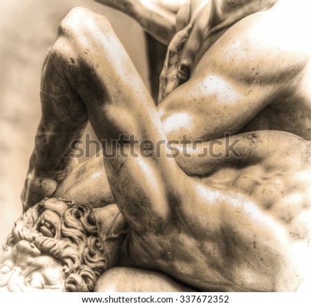 Centaur head close up of Hercules and Nesso centaur statue in Loggia dei Lanzi in sepia tone in Florence, Italy
