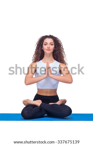 Studio shot of a young fit woman doing yoga exercises on white background