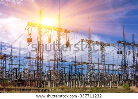 distribution electric substation with power lines and transformers, at sunset Royalty-Free Stock Photo #337711232