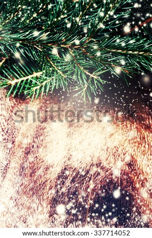 Dark brown wood texture with white snow,  stars and fir tree  in vintage style . Christmas background. Christmas card