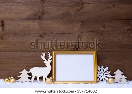 Christmas Card With Picture Frame On White Snow. Copy Space For Advertisement. White Christmas Decoration Like Snowflake, Tree, Golden Balls And Reindeer. Vintage, Wooden Background.
