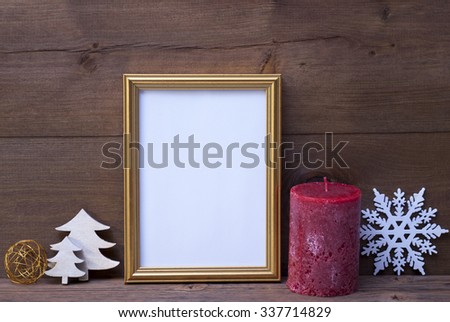 Golden Picture Frame With White Christmas Decoration Like Tree, Candle And Snowflake. Copy Space For Advertisement. Vintage Wooden And Rustic Retro Background. Christmas Card For Seasons Greetings