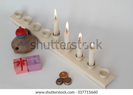 Jewish holiday hanukkah celebration with vintage menorah, donuts, dreidels, jug, on a white background