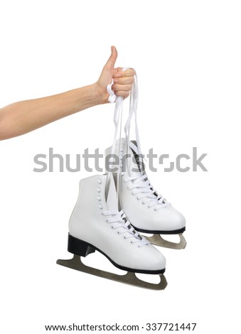 Hand with thumb up sign holding woman ice skates isolated on a white background
