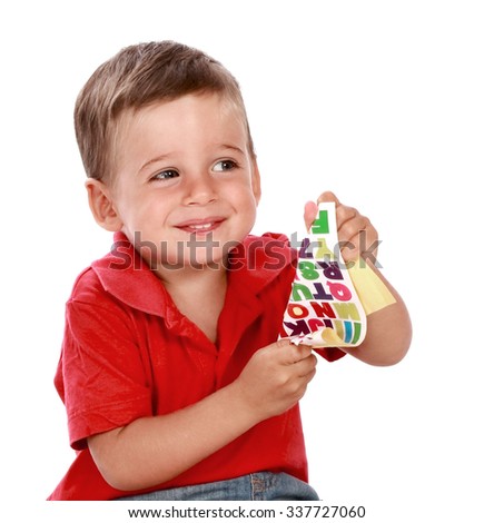 child with stickers of letters 