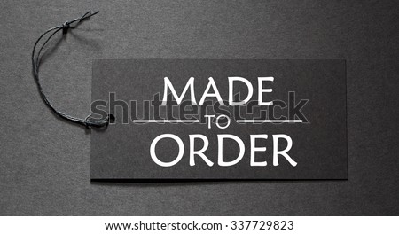 Made to Order text on a black tag on black paper background
