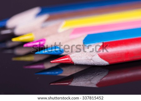 Macro image of colored wooden pencils .