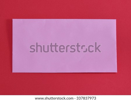 pink envelope on red color foam board
