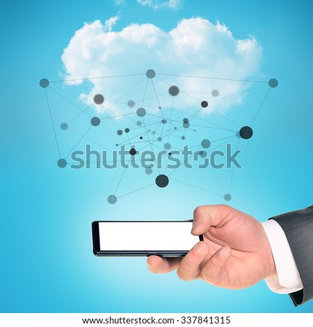 Businessman arm holding smartphone on blue sky background