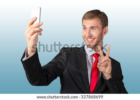 Handsome businessman taking a selfie with a mobile phone