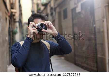 Young man taking photos in Barcelona