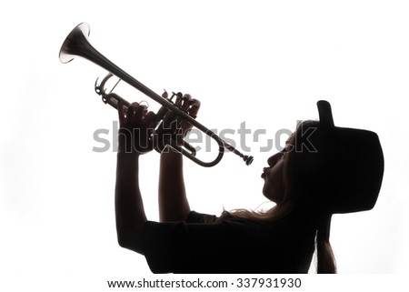 trumpet and a woman - beautiful young woman with a hat playing a trumpet - back light - shadows - musical instruments - trumpet - valves and tubes - mouthpiece for playing