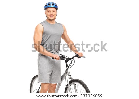 Young male biker posing next to his bicycle and smiling isolated on white background
