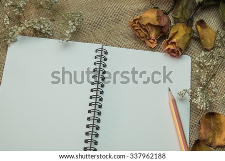 blank notebook on fabric wallpaper