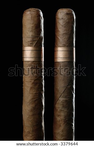 Couple of cuban hand-rolled cigars on black